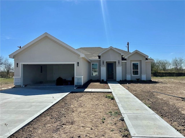 ranch-style home with stucco siding, a garage, roof with shingles, and driveway