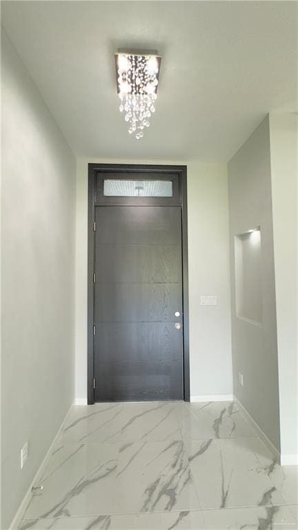 entryway featuring an inviting chandelier