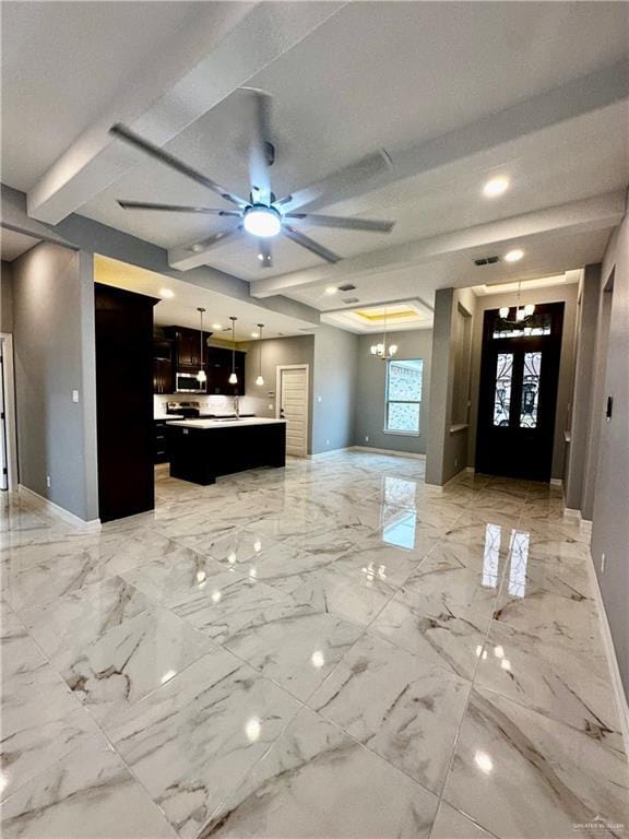 kitchen with pendant lighting, a center island, ceiling fan with notable chandelier, and french doors