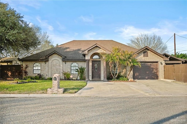 view of front of property featuring a garage and a front lawn