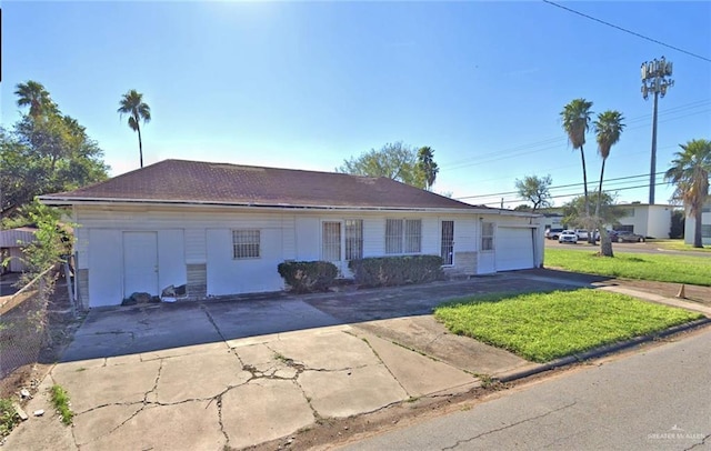 ranch-style home with a front lawn