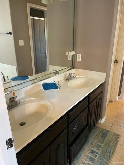 704 N Drennan St N, Edinburg, TX 78541 - full bath with tile patterned flooring, double vanity, and a stall shower