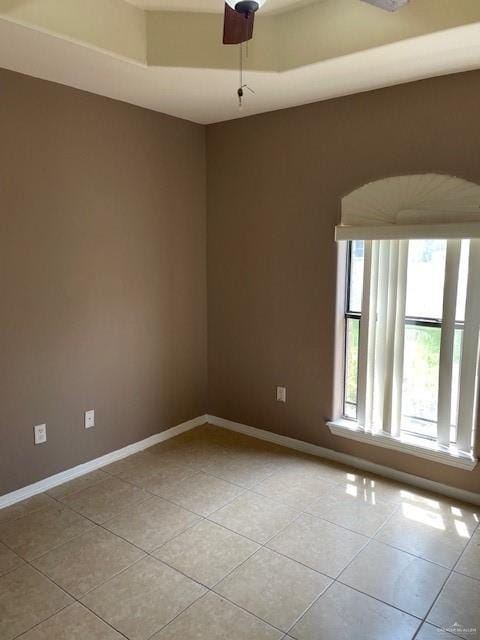 704 N Drennan St N, Edinburg, TX 78541 - empty room with healthy amount of natural light, light tile patterned flooring, and baseboards