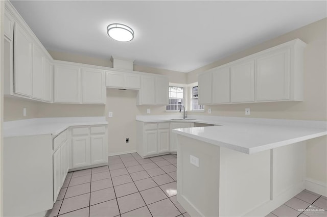1507 Vatia Blvd, Mission, TX 78572 - kitchen featuring a peninsula, light tile patterned floors, white cabinets, and light countertops