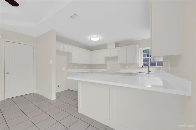 1507 Vatia Blvd, Mission, TX 78572 - kitchen with a peninsula, light tile patterned flooring, light countertops, and white cabinets