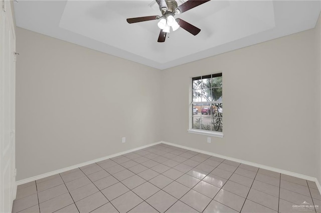 1507 Vatia Blvd, Mission, TX 78572 - empty room with light tile patterned flooring, a ceiling fan, and a tray ceiling
