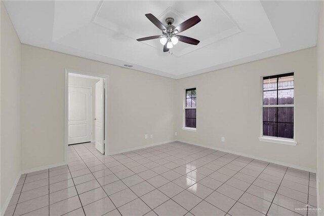 1507 Vatia Blvd, Mission, TX 78572 - unfurnished room with a tray ceiling, a ceiling fan, and light tile patterned floors