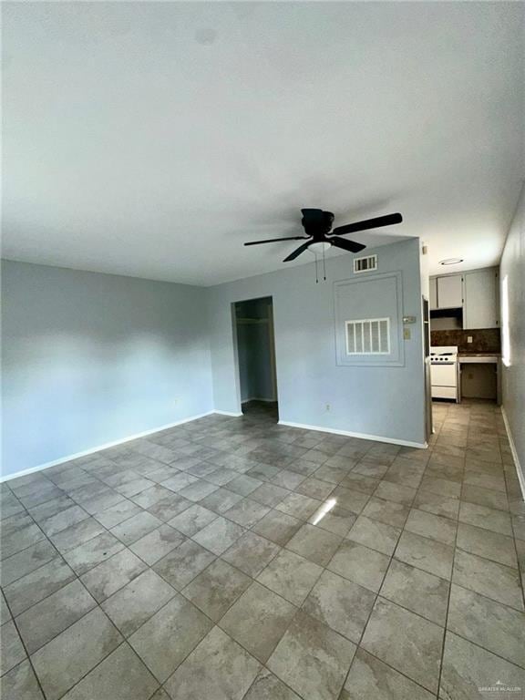 unfurnished living room with ceiling fan