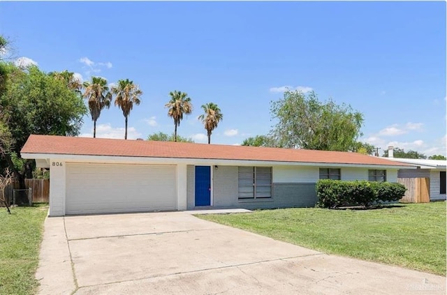 ranch-style house featuring a garage and a front lawn