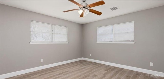 spare room with ceiling fan and light hardwood / wood-style floors