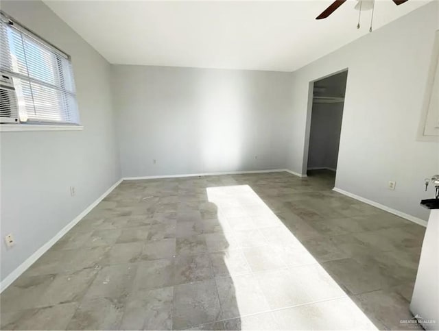 unfurnished bedroom with ceiling fan and a closet