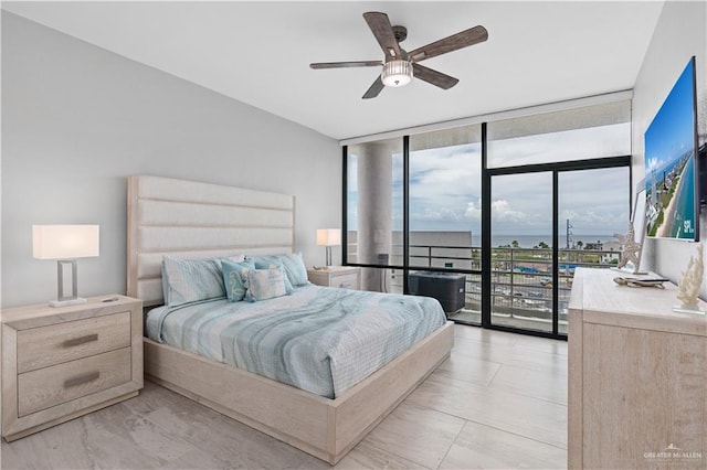 1000 Padre Blvd, South Padre Island, TX 78597 - bedroom featuring a wall of windows, access to outside, and a ceiling fan