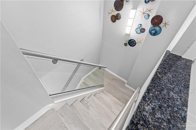 1000 Padre Blvd, South Padre Island, TX 78597 - staircase featuring wood finished floors and baseboards