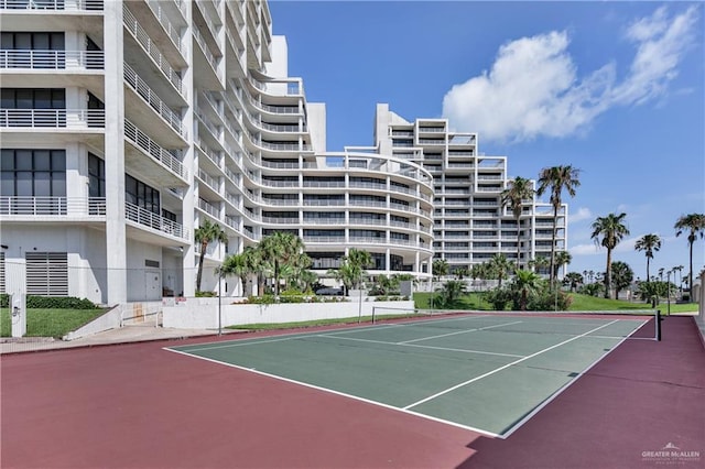 view of tennis court featuring basketball hoop