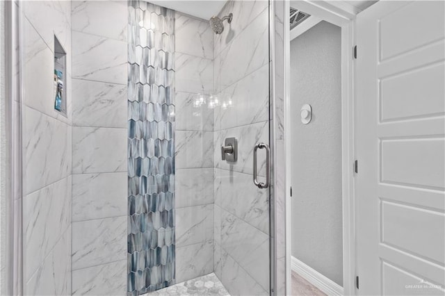 bathroom with tiled shower