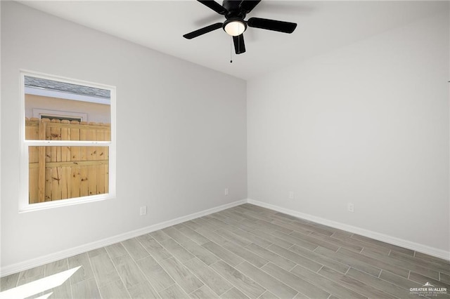 spare room with hardwood / wood-style flooring and ceiling fan