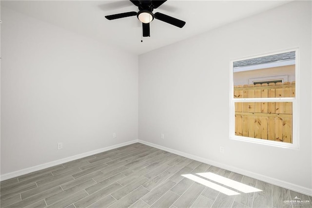 empty room with hardwood / wood-style floors and ceiling fan