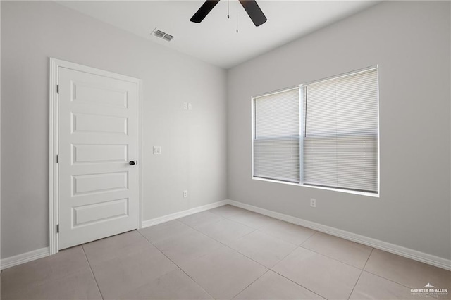 spare room featuring light tile patterned floors and ceiling fan