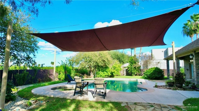 view of swimming pool with an in ground hot tub