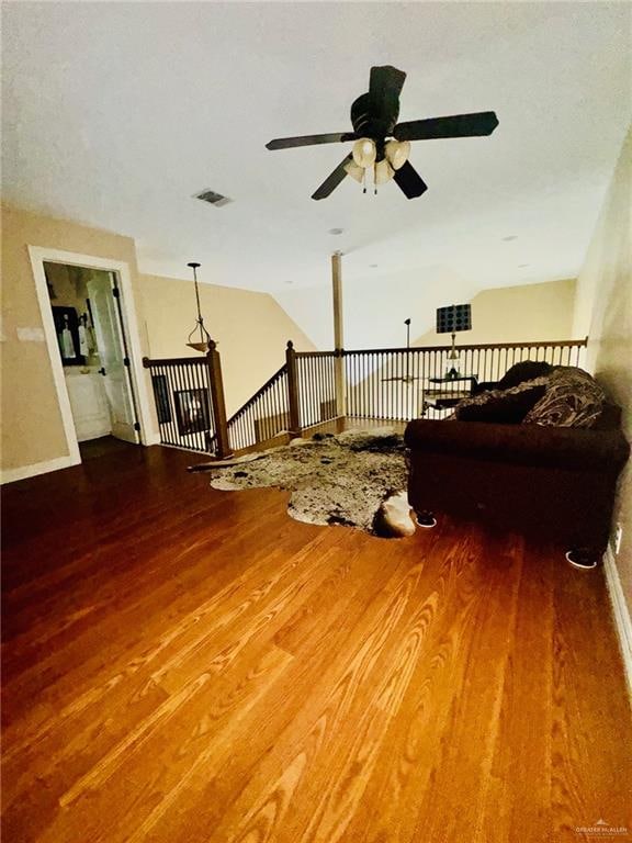 living room featuring ceiling fan and hardwood / wood-style floors