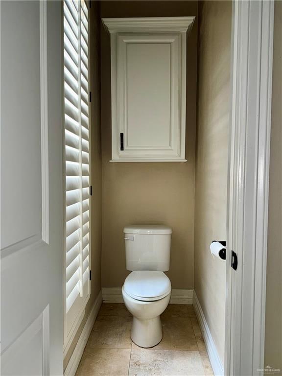 bathroom with tile patterned flooring and toilet