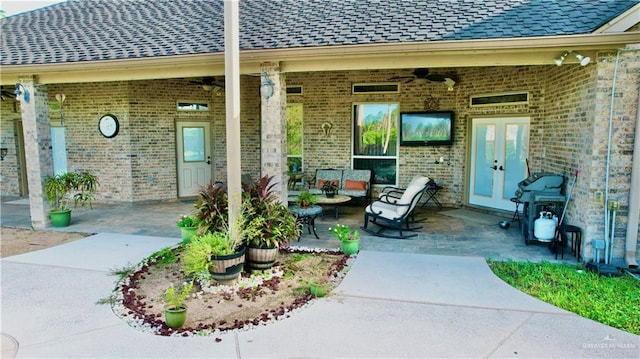 doorway to property with a patio area, ceiling fan, french doors, and an outdoor living space