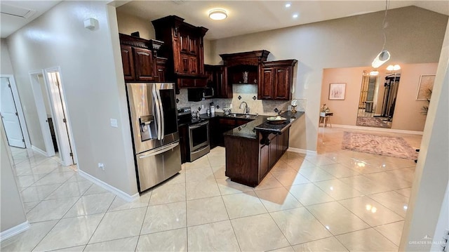 kitchen with backsplash, sink, dark brown cabinets, and appliances with stainless steel finishes