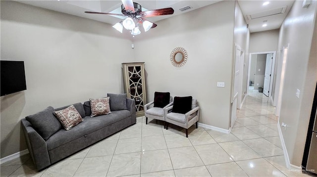 tiled living room featuring a high ceiling and ceiling fan