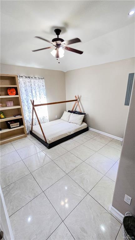 unfurnished bedroom featuring ceiling fan and light tile patterned floors