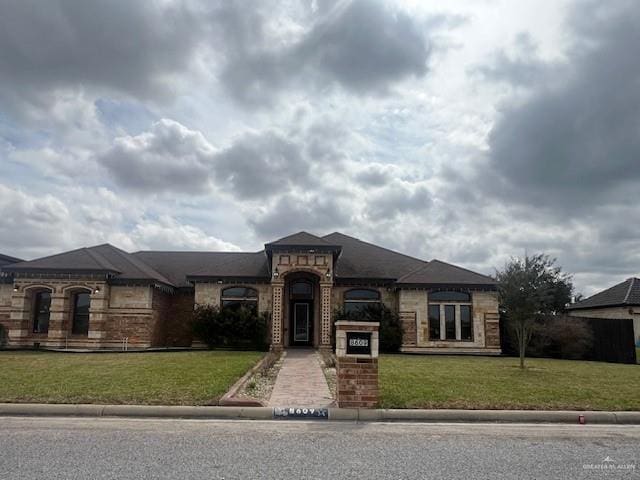 view of front of house featuring a front yard and brick siding