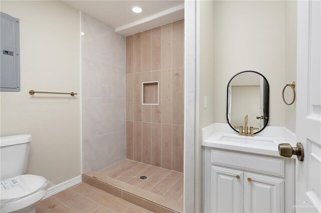 820 Beech Ave Unit 1, Mcallen, TX 78501 - bathroom featuring toilet, electric panel, a shower stall, recessed lighting, and vanity
