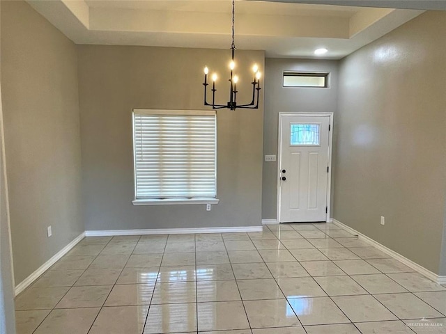 entrance foyer with light tile patterned floors, baseboards, and a notable chandelier