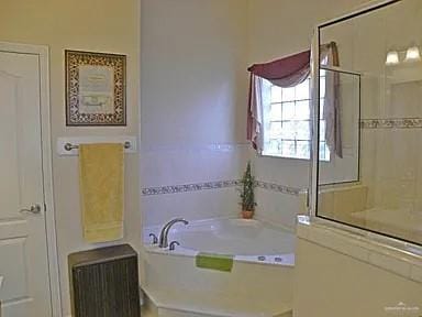 bathroom with radiator heating unit and a tub