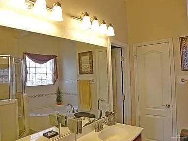 bathroom with plus walk in shower and vanity