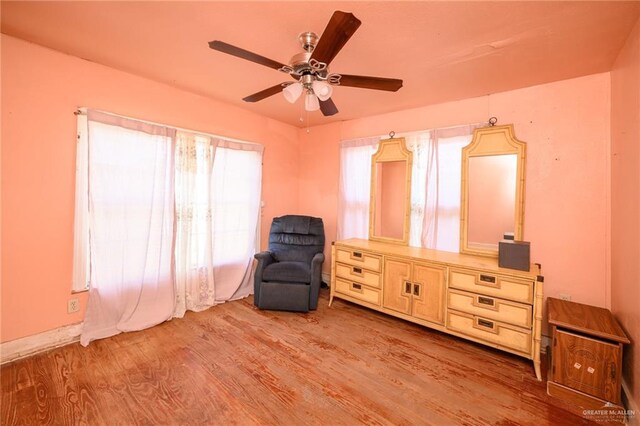 912 W Pierce Ave, Harlingen, TX 78550 - living area with wood finished floors and ceiling fan