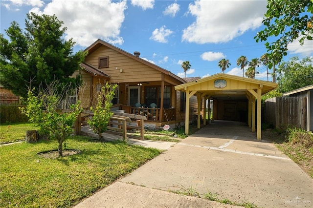 912 W Pierce Ave, Harlingen, TX 78550 - view of front of home with concrete driveway, a carport, and a porch