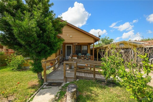 912 W Pierce Ave, Harlingen, TX 78550 - back of property with a wooden deck and a yard