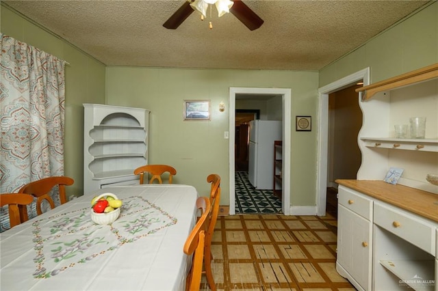 912 W Pierce Ave, Harlingen, TX 78550 - dining area featuring light floors, ceiling fan, and a textured ceiling