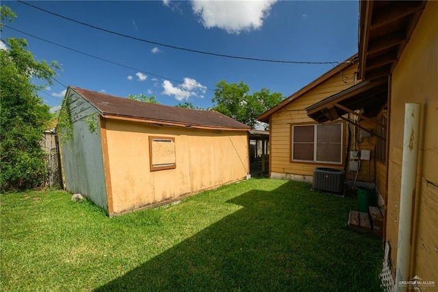 912 W Pierce Ave, Harlingen, TX 78550 - view of grassy yard with cooling unit and an outbuilding
