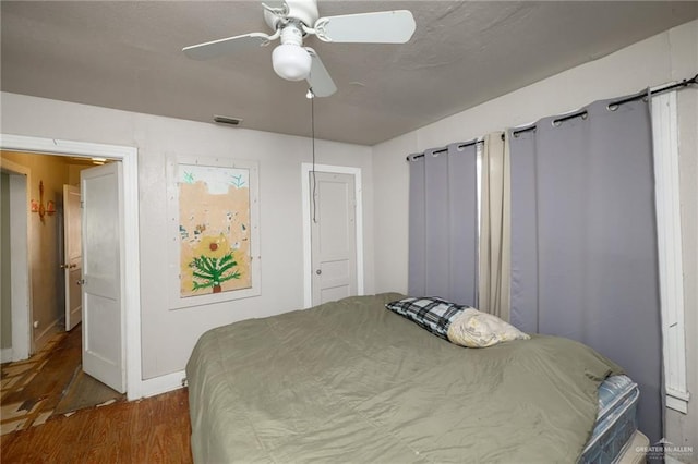 912 W Pierce Ave, Harlingen, TX 78550 - bedroom featuring wood finished floors, baseboards, and ceiling fan