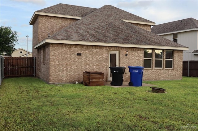 5712 River Rd, Mcallen, TX 78504 - back of property featuring a shingled roof, brick siding, and a fenced backyard
