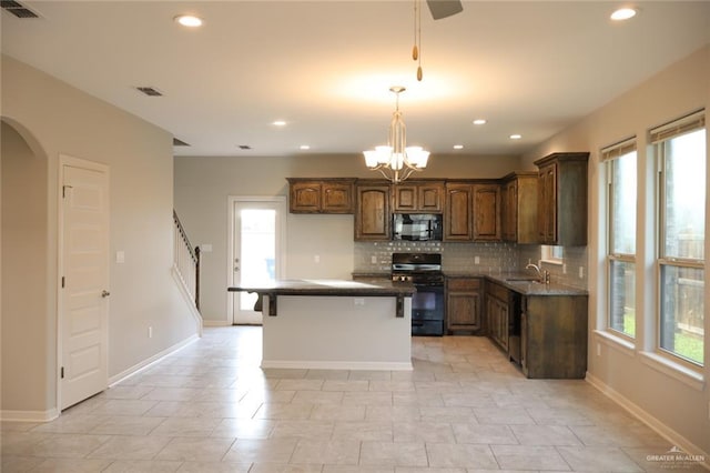5712 River Rd, Mcallen, TX 78504 - kitchen featuring black appliances, plenty of natural light, backsplash, recessed lighting, and pendant lighting