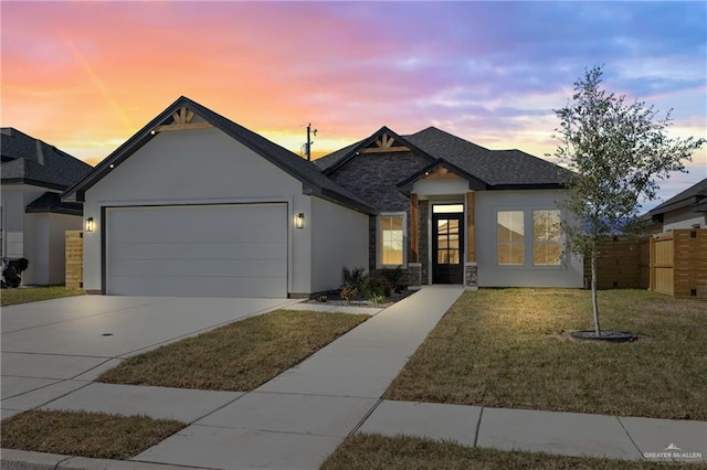 view of front of house with a garage and a lawn