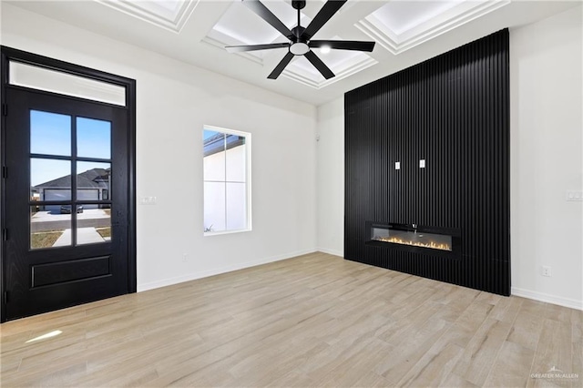 entryway with light hardwood / wood-style flooring, ceiling fan, coffered ceiling, a fireplace, and beamed ceiling