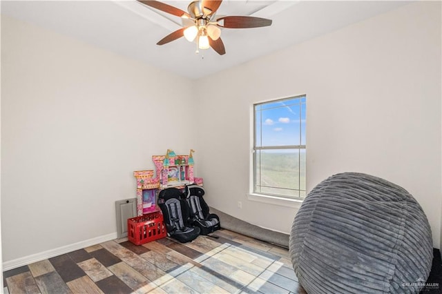 rec room featuring wood-type flooring and ceiling fan