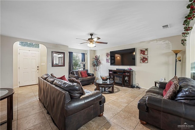 tiled living room featuring ceiling fan