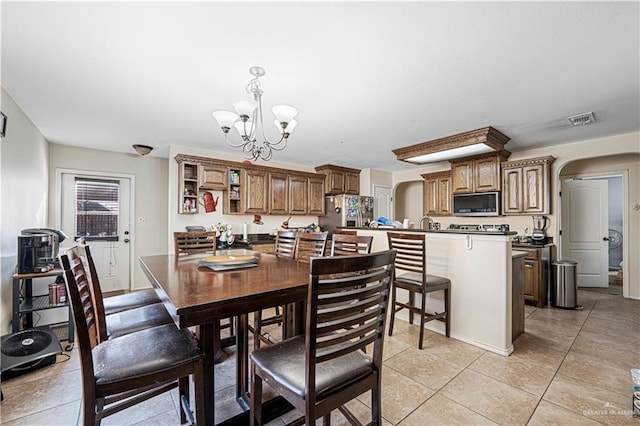 dining space featuring an inviting chandelier and light tile patterned floors