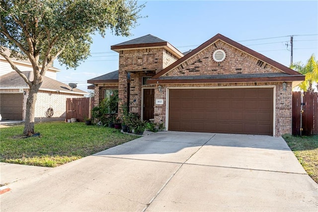 view of front of home featuring a garage and a front yard