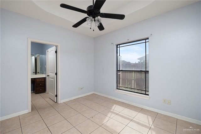 tiled spare room featuring ceiling fan