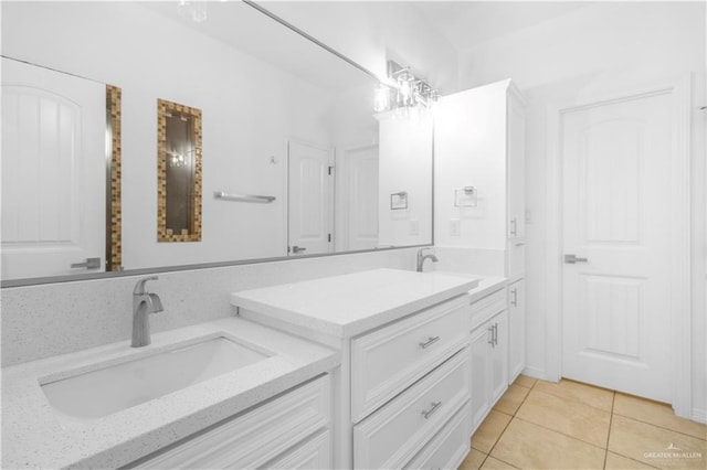 bathroom with a sink, tile patterned floors, and double vanity
